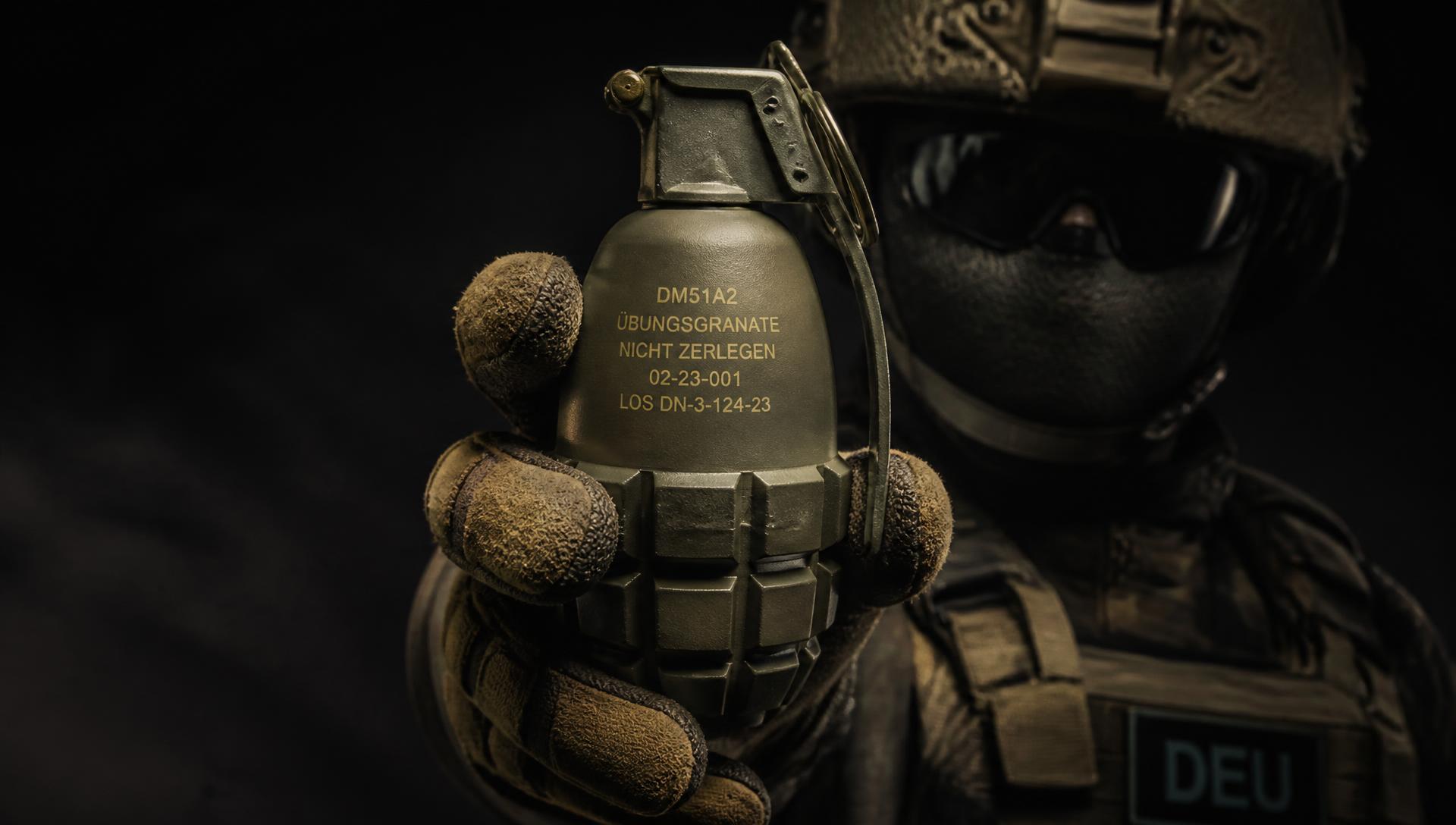 MilSim operator holding a QuietBlast DM-Replica practice grenade during a CQB drill in a dark shoot-house